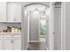 Hallway with archway leading to bathroom, kitchen nearby at 5615 Nw 202Nd Pl, Mc Intosh, FL 32664