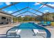Inviting screened pool and spa with lounge chairs at 5615 Nw 202Nd Pl, Mc Intosh, FL 32664