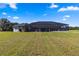 Home with a screened-in pool area and expansive lawn at 5615 Nw 202Nd Pl, Mc Intosh, FL 32664