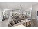 Open concept living room with gray sectional sofa and wood-look floors at 5615 Nw 202Nd Pl, Mc Intosh, FL 32664
