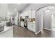 White kitchen with stainless steel appliances and gray herringbone backsplash at 5615 Nw 202Nd Pl, Mc Intosh, FL 32664