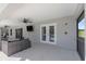 Covered patio with comfortable seating and access to pool area at 5615 Nw 202Nd Pl, Mc Intosh, FL 32664