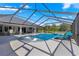 Inviting pool and spa with covered patio and lounge chairs at 5615 Nw 202Nd Pl, Mc Intosh, FL 32664