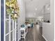 Bright entryway with view into living and kitchen areas at 5615 Nw 202Nd Pl, Mc Intosh, FL 32664