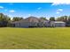 Single-story house with attached garage, set on a large lot at 5615 Nw 202Nd Pl, Mc Intosh, FL 32664