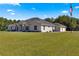 House exterior showcasing a one-story home with landscaping at 5615 Nw 202Nd Pl, Mc Intosh, FL 32664