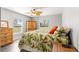 Bedroom with leafy bedding, wood furniture, and ceiling fan at 5615 Nw 202Nd Pl, Mc Intosh, FL 32664