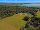 Aerial view showing home, detached garage, and large lot near the water at 5615 Nw 202Nd Pl, Mc Intosh, FL 32664