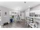 Bright dining area with white table and chairs near kitchen at 5615 Nw 202Nd Pl, Mc Intosh, FL 32664