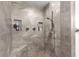 Large walk-in shower with built-in shelves and pebble floor at 5615 Nw 202Nd Pl, Mc Intosh, FL 32664