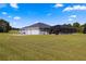 Back exterior with pool and screened enclosure at 5615 Nw 202Nd Pl, Mc Intosh, FL 32664