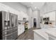 Stainless steel refrigerator in a modern kitchen with white shaker cabinets at 5615 Nw 202Nd Pl, Mc Intosh, FL 32664