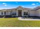 House entrance with stone accents and landscaping at 5615 Nw 202Nd Pl, Mc Intosh, FL 32664