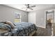 Bright bedroom with a queen bed, double doors to a closet, and tile floors at 5615 Nw 202Nd Pl, Mc Intosh, FL 32664