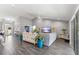 Spacious living room with vaulted ceiling, gray sofa, and large windows at 5615 Nw 202Nd Pl, Mc Intosh, FL 32664