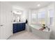 Modern bathroom with a freestanding tub, a single vanity, and plenty of natural light at 5615 Nw 202Nd Pl, Mc Intosh, FL 32664