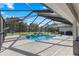 Large screened pool and spa with patio furniture and grill at 5615 Nw 202Nd Pl, Mc Intosh, FL 32664