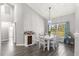 Dining room with farmhouse table and view to living room at 5615 Nw 202Nd Pl, Mc Intosh, FL 32664