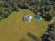 Aerial view of house, pool, and detached garage on large lot at 5615 Nw 202Nd Pl, Mc Intosh, FL 32664