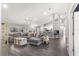 Open living space with a large sectional sofa and tile floors at 5615 Nw 202Nd Pl, Mc Intosh, FL 32664