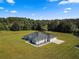 Aerial view of single-story home with attached garage and large yard at 5615 Nw 202Nd Pl, Mc Intosh, FL 32664