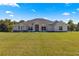 Single-story home with a welcoming front porch at 5615 Nw 202Nd Pl, Mc Intosh, FL 32664