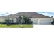 Beautiful one-story home with a three-car garage and lush landscaping at 5858 Nw 27Th Pl, Ocala, FL 34482