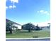 Landscaped front yard with palm trees and spacious lawn at 5858 Nw 27Th Pl, Ocala, FL 34482