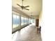 Bright sunroom with tile floor and ceiling fans at 5858 Nw 27Th Pl, Ocala, FL 34482