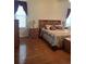 Bedroom with wood flooring, wooden furniture, and large windows at 5858 Nw 27Th Pl, Ocala, FL 34482