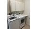 Laundry room with washer, dryer, and cabinets at 5858 Nw 27Th Pl, Ocala, FL 34482