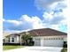 Spacious house with a three-car garage, palm trees, and well-manicured lawn at 5858 Nw 27Th Pl, Ocala, FL 34482