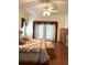 Main bedroom with wood floors, ceiling fan, and access to backyard at 5858 Nw 27Th Pl, Ocala, FL 34482