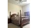 Spacious bedroom with hardwood floors, large bed and ceiling fan at 5858 Nw 27Th Pl, Ocala, FL 34482