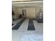 Spacious two-car garage with overhead storage and floor mats at 5858 Nw 27Th Pl, Ocala, FL 34482