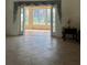 Sunroom with access to backyard, featuring large windows and tile flooring at 5858 Nw 27Th Pl, Ocala, FL 34482