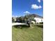House exterior with brown roof, white walls, and palm tree at 5858 Nw 27Th Pl, Ocala, FL 34482
