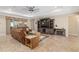 Bright living room featuring a large TV and fireplace at 8445 Sw 93Rd Cir, Ocala, FL 34481