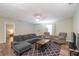 Living room with sectional sofa, two armchairs, and wood-look floors at 5456 Nw 64Th St, Ocala, FL 34482