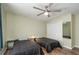 Bedroom with two twin beds, window, closet, and ceiling fan at 5456 Nw 64Th St, Ocala, FL 34482