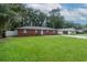 Brick ranch house with a large front yard and mature trees at 5456 Nw 64Th St, Ocala, FL 34482