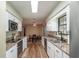 Open concept kitchen with white cabinets and a view of the dining area at 5456 Nw 64Th St, Ocala, FL 34482