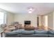 Living room with sectional sofa, two armchairs, and wood-look floors at 5456 Nw 64Th St, Ocala, FL 34482
