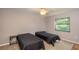 Spacious bedroom with two twin beds, nightstands, and ceiling fan at 5456 Nw 64Th St, Ocala, FL 34482