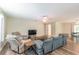 Spacious living room with sectional sofa and wood-look floors at 5456 Nw 64Th St, Ocala, FL 34482