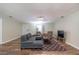 Living room with sectional sofa, two armchairs, and wood-look floors at 5456 Nw 64Th St, Ocala, FL 34482