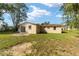 Back of the house, showcasing a sliding glass door and a spacious yard at 11 Cedar Trace Crse, Ocala, FL 34472