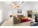 Bright living room features a stone fireplace, tile floors, and a comfy sofa at 4980 Sw 195Th Ave, Dunnellon, FL 34431