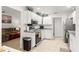 Modern kitchen boasts white cabinets, granite countertops, and stainless steel appliances at 4980 Sw 195Th Ave, Dunnellon, FL 34431