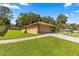 Single car garage with stone accents and a walkway at 4980 Sw 195Th Ave, Dunnellon, FL 34431